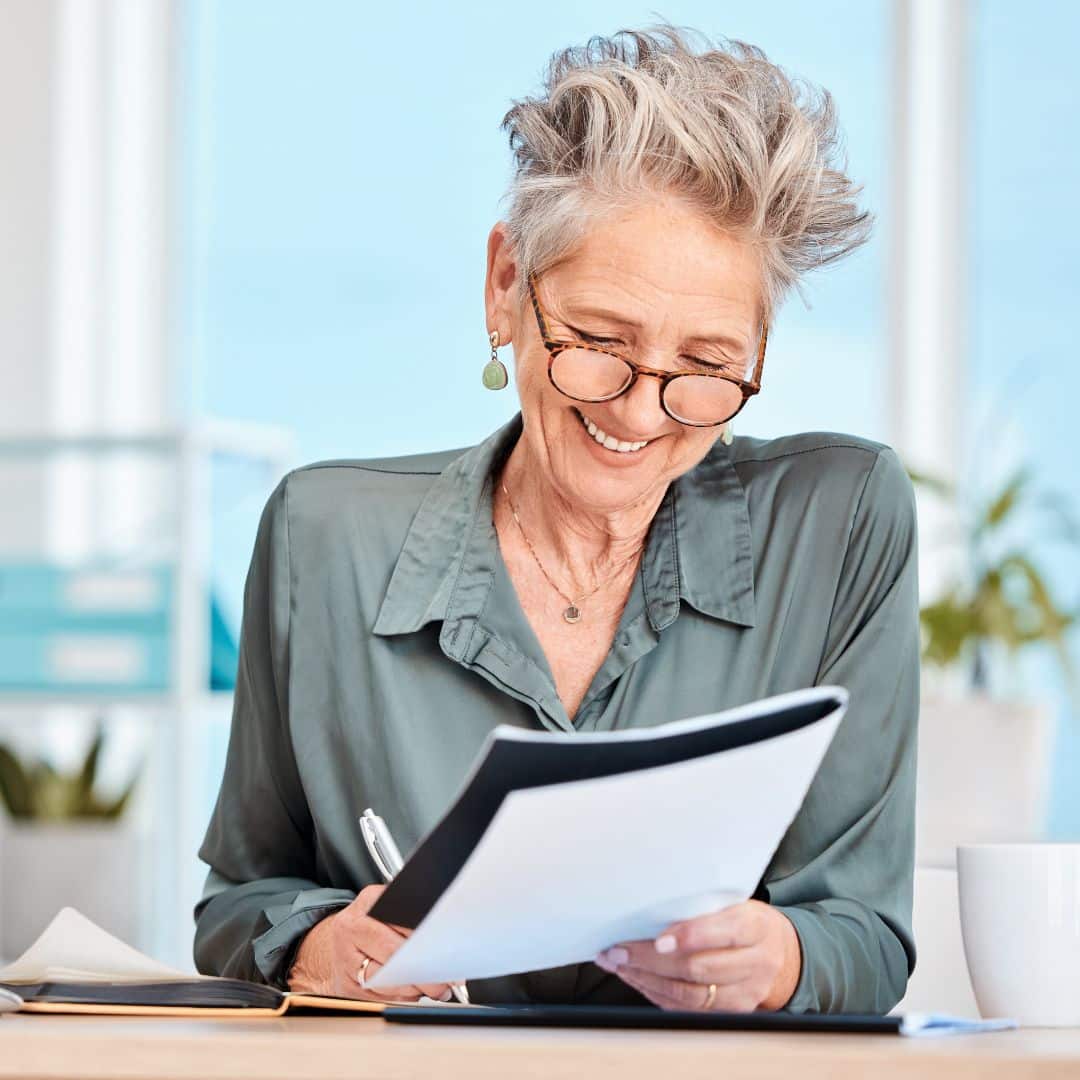 Happy law firm owner reviewing a report.