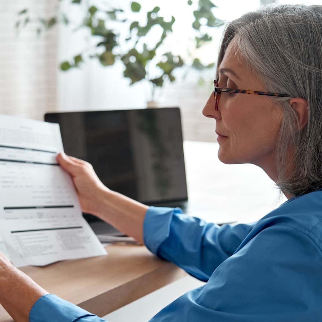 A bookkeeper reviewing receipts and paperwork from a law firm client.
