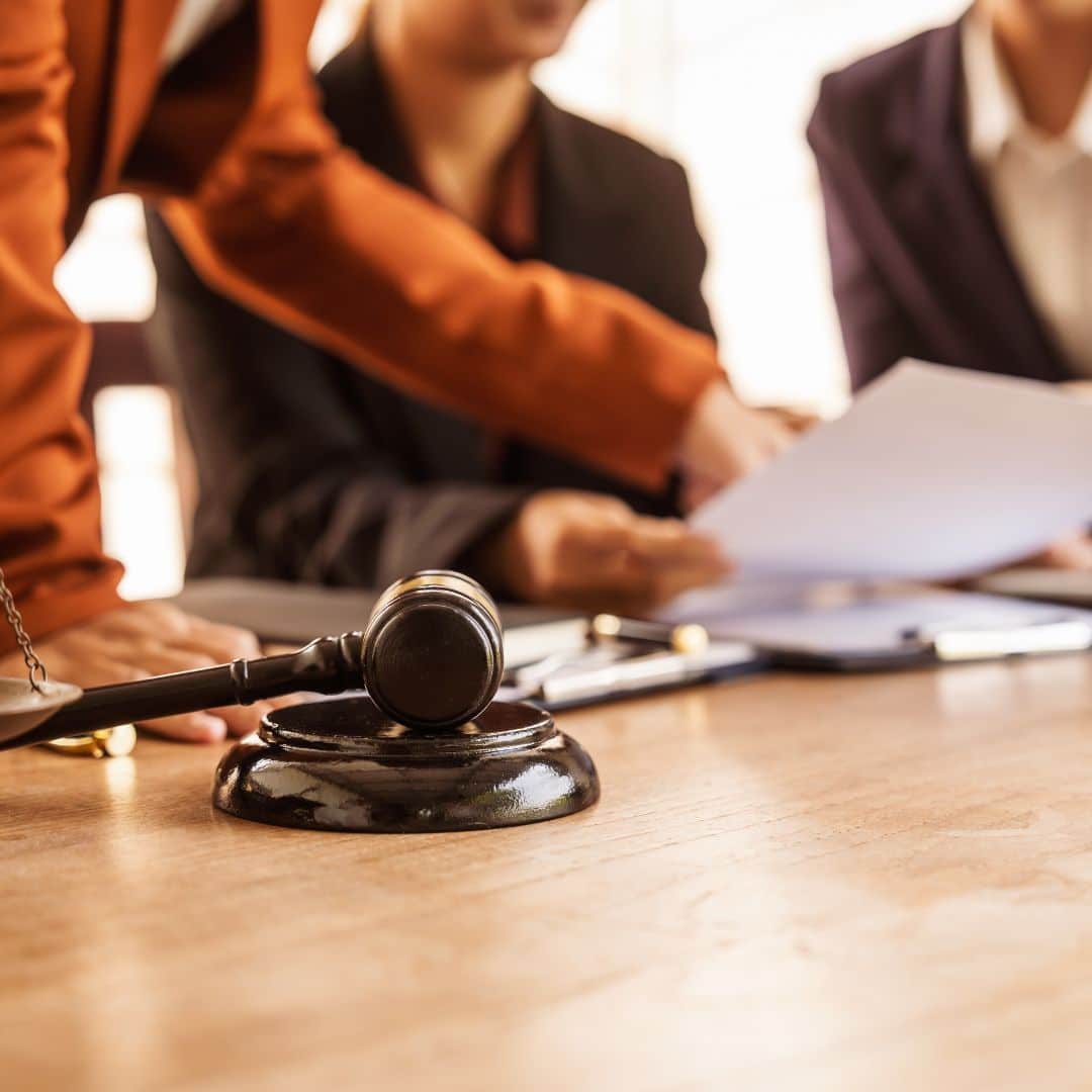A group of lawyers meeting around a conference table.